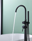 Freestanding Black Tub Faucet with Handheld Shower in use, water flowing into bathtub.