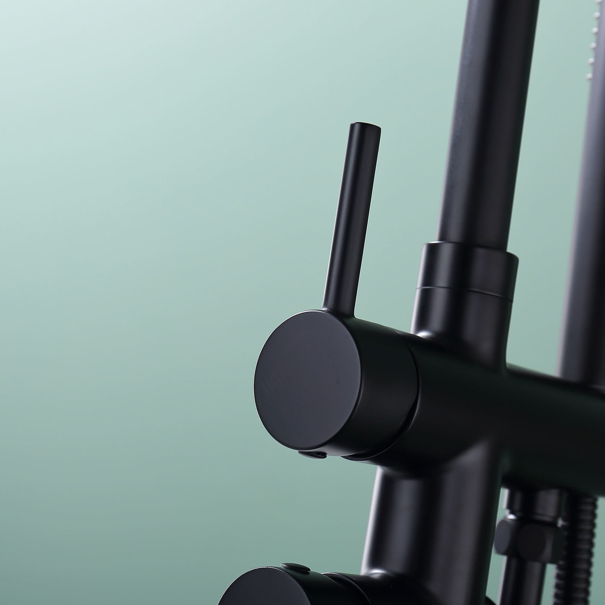 Close-up of upper lever on Freestanding Black Tub Faucet with Handheld Shower.