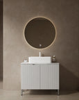 30-inch white bathroom vanity styled in a modern bathroom with freestanding layout.