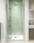 Open-position view of the 32x72 frameless bi fold shower door in a modern bathroom | Ace Decor