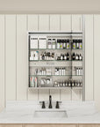 Single-door medicine cabinet filled with cosmetics on glass shelves.