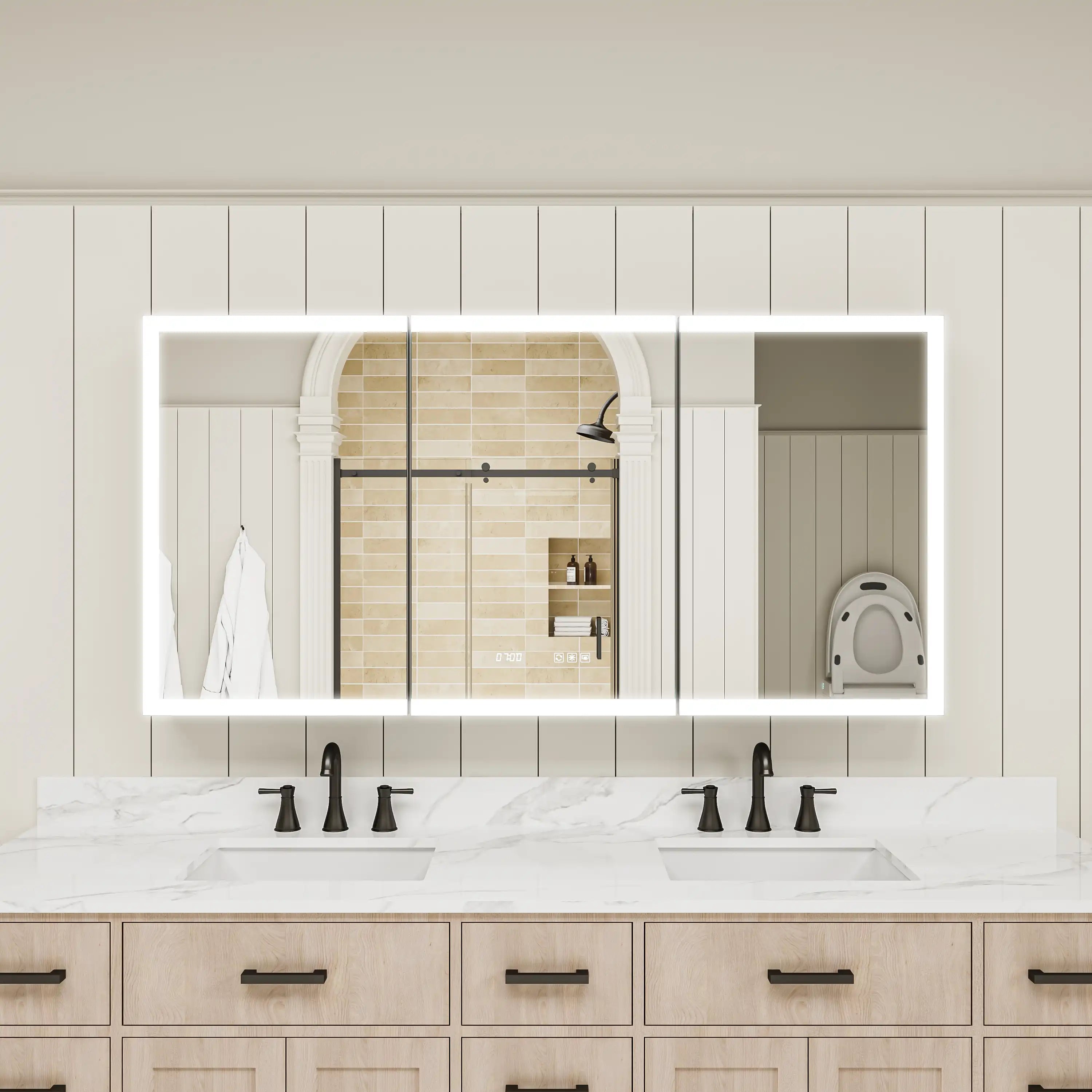 Three-door lighted medicine cabinet installed in double sink bathroom