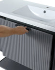 Black metal handle and fluted door panel of the 48-inch bathroom vanity in rock grey finish.