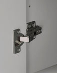 Stainless steel hinge of the grey linen cabinet door.