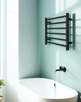 22 x 20 black heating towel racks installed above freestanding bathtub for modern bathroom decor | Ace Decor