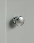 Metal door handle close-up on Norrin 67.3 inch grey tall narrow bathroom storage cabinet.