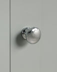 Metal door handle close-up on Norrin 67.3 inch grey tall narrow bathroom storage cabinet.