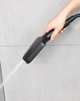 Matte black hand shower using the top cleaning spray mode.