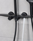 Matte black tub spout delivering a steady water flow for bathtub filling.