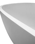 Close-up of rounded rim and seamless finish on 67" stain-resistant solid surface soaking bathtub.