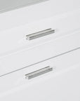 Close-up of sleek drawer handle on white bathroom linen cabinet, emphasizing modern design.