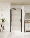 Modern walk-in shower with black-framed pivot door in a white marble bathroom | Ace Decor