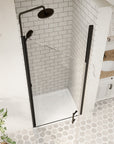 Top-down view of closed matte black framed pivot shower door in a tiled bathroom | Ace Decor