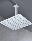 Modern bathroom view showing the Lorton 12" white rain shower head mounted overhead with a wide spray area.