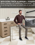 Man sitting on reinforced medicine cabinet frame made of extra-thick aluminum, supporting 176 lbs without bending.