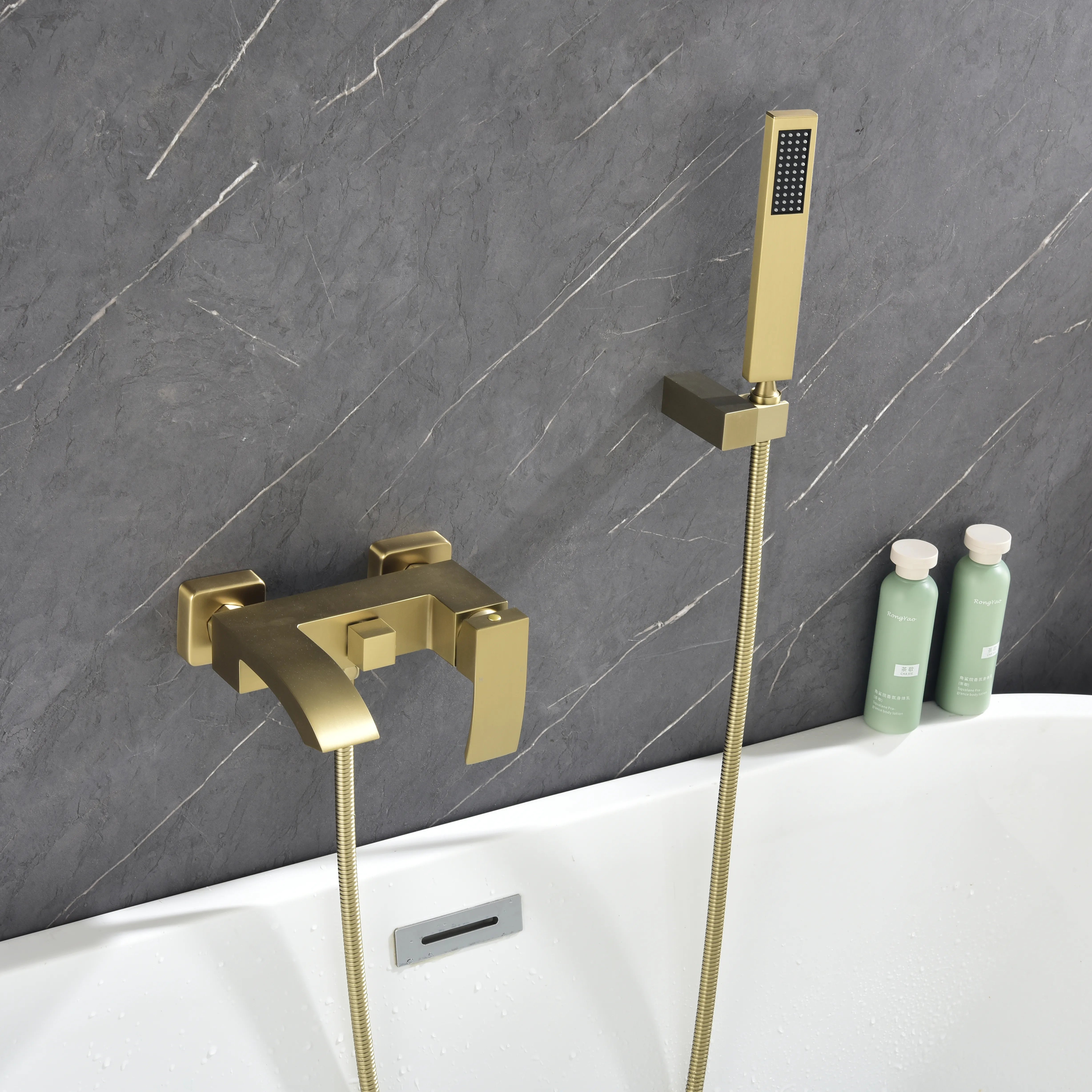 AURELIA Brushed Gold Wall-Mounted Bathtub Faucet with handheld shower installed in modern bathroom setting.