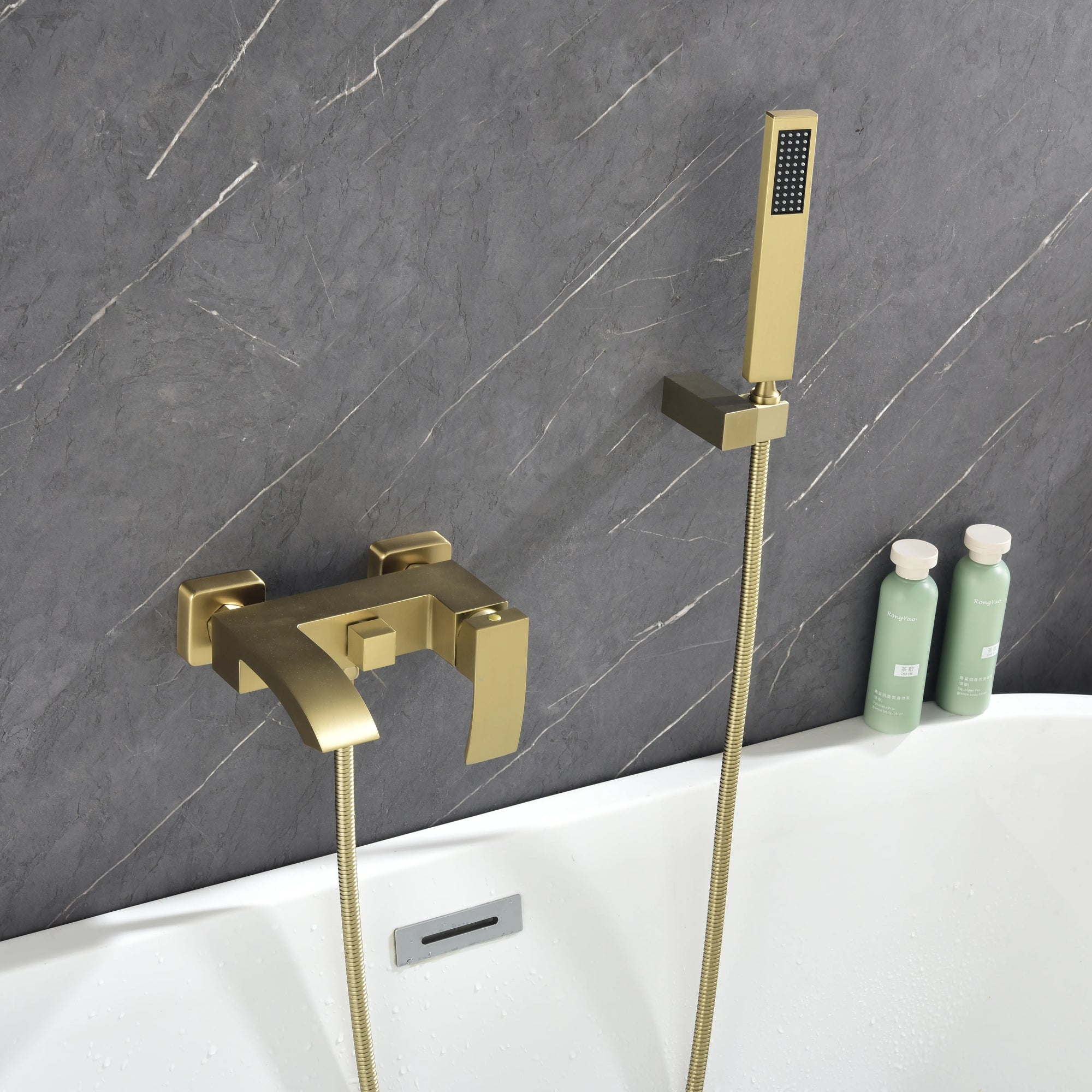 AURELIA Brushed Gold Wall-Mounted Bathtub Faucet with handheld shower installed in modern bathroom setting.