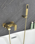 AURELIA Brushed Gold Wall-Mounted Bathtub Faucet with handheld shower installed in modern bathroom setting.