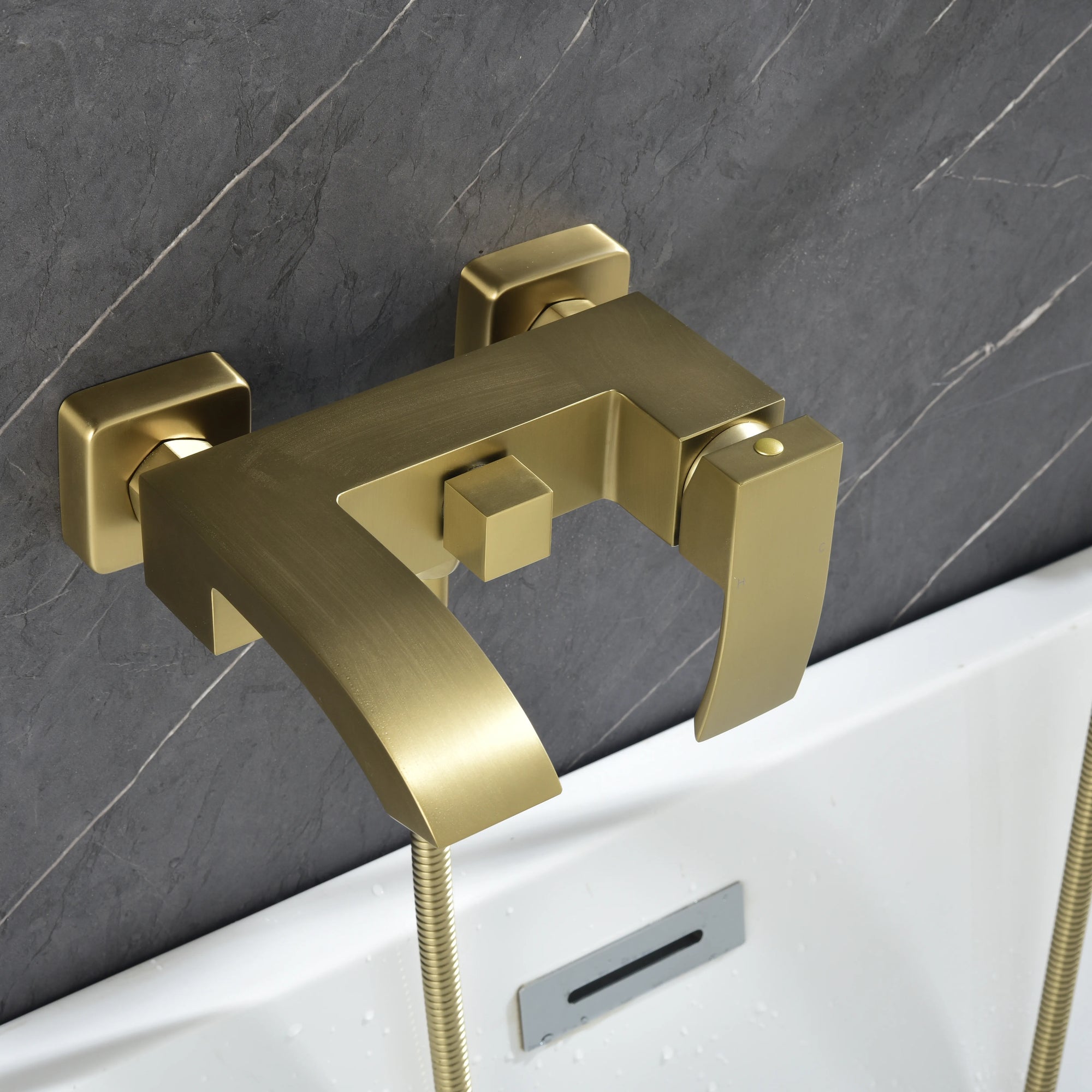 AURELIA Brushed Gold Wall-Mounted Bathtub Faucet close-up view installed above tub.