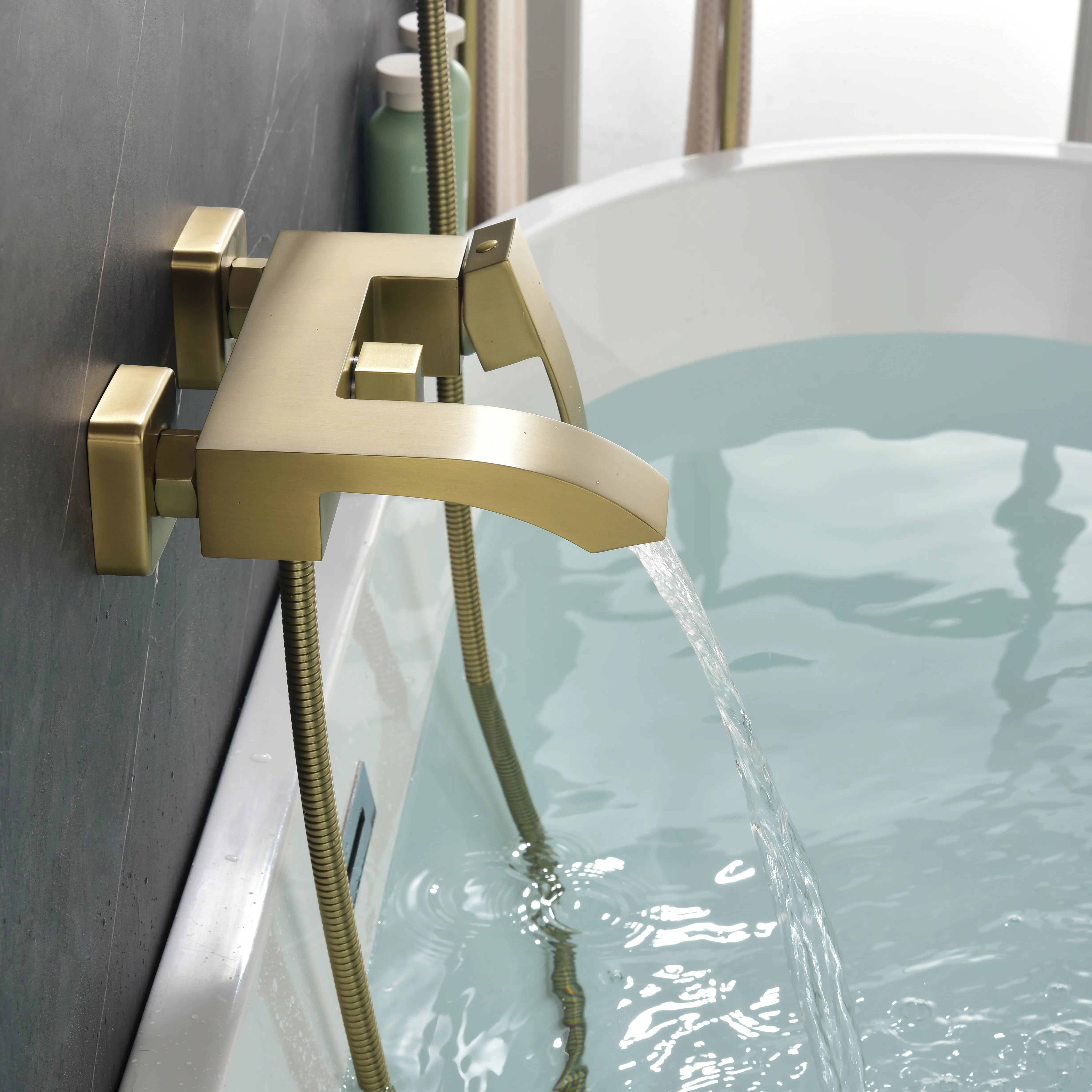 AURELIA Brushed Gold Wall-Mounted Bathtub Faucet filling tub with steady water flow.