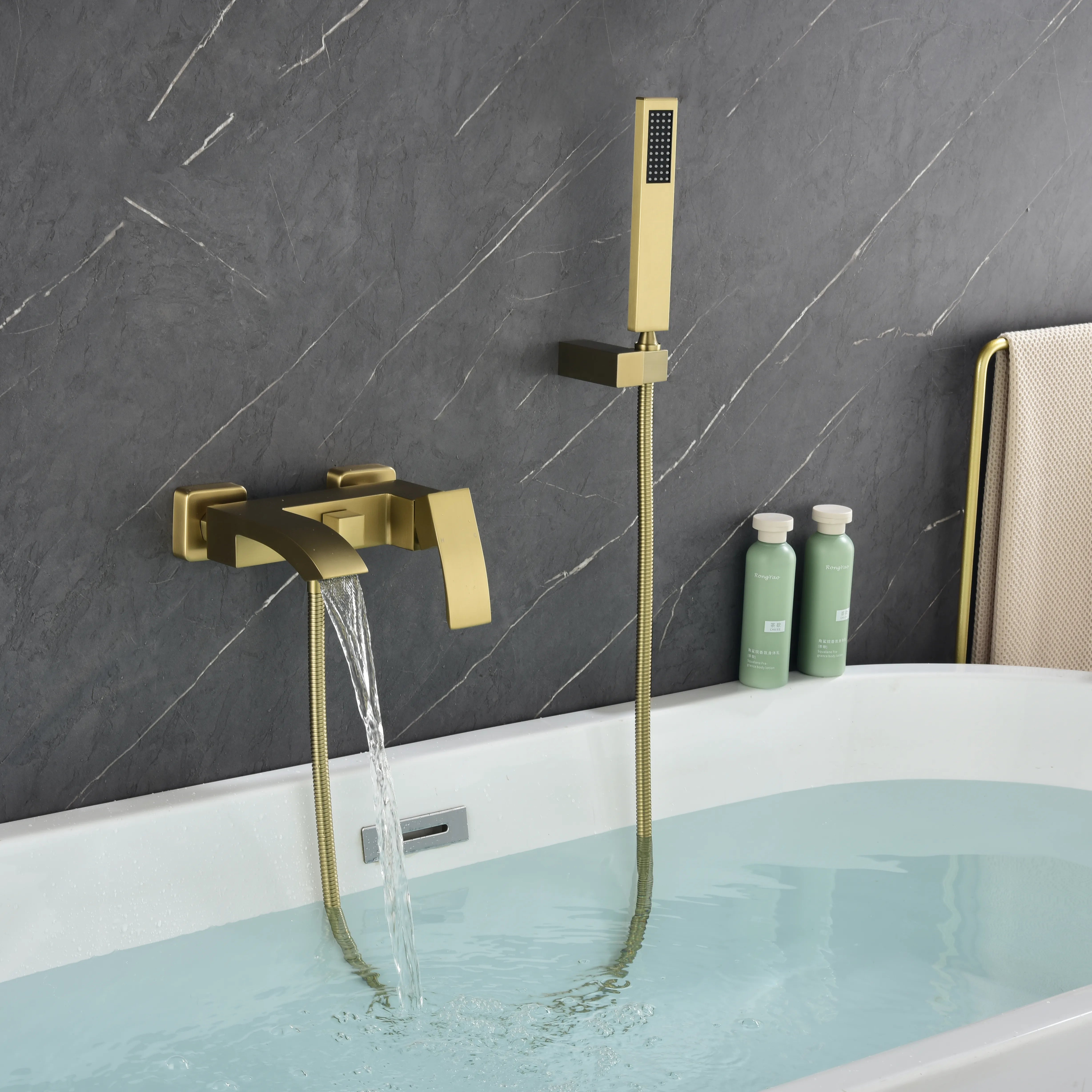 AURELIA Brushed Gold Wall-Mounted Bathtub Faucet filling tub with steady water flow.