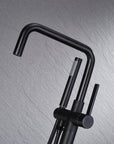 Close-up of Black Freestanding Tub Faucet spout and handheld shower, sleek matte black finish for modern bathroom design.