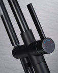 Close-up of Black Freestanding Tub Faucet handle with hot and cold indicators.