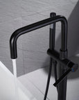 Matte black freestanding tub faucet with a curved rotating spout filling a white bathtub, handheld shower, and single lever control.