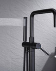 Black Freestanding Tub Faucet with handheld shower spraying water.