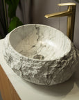 Round bathroom sink with ceramic inner basin featuring realistic stone-pattern finish