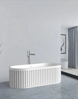 Nectar Series 67-inch solid surface bathtub in a serene bathroom with ocean view, minimalist decor, and natural light.