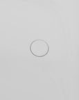 Close-up of the sleek pop-up circular drain in the white 51" solid surface soaking tub, minimalist design.