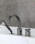 FLUNIX Matte Black Waterfall Roman Tub Faucet Set installed on bathtub, handheld shower spraying water.