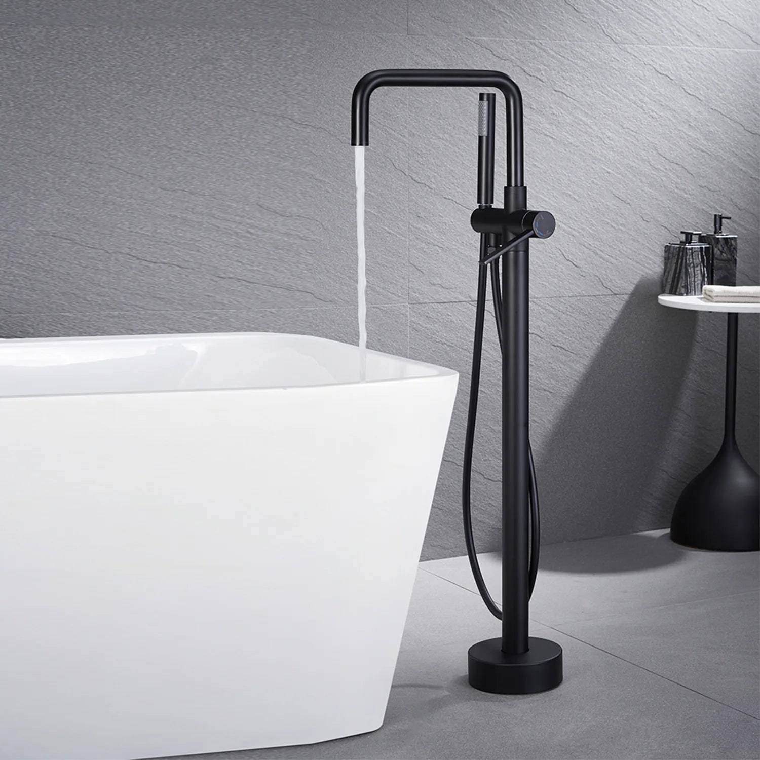Black Freestanding Tub Faucet filling white bathtub.