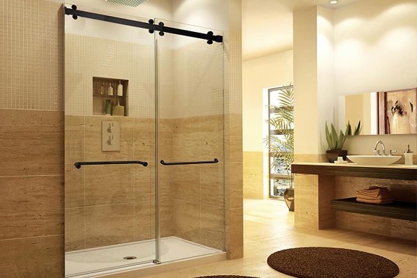 Spacious bathroom featuring shower doors sliding glass with black hardware and natural stone walls