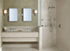 A stylish bathroom featuring best luxury shower systems with a rainfall shower, handheld sprayer, body jets, and elegant double vanity design. |ACE DECOR