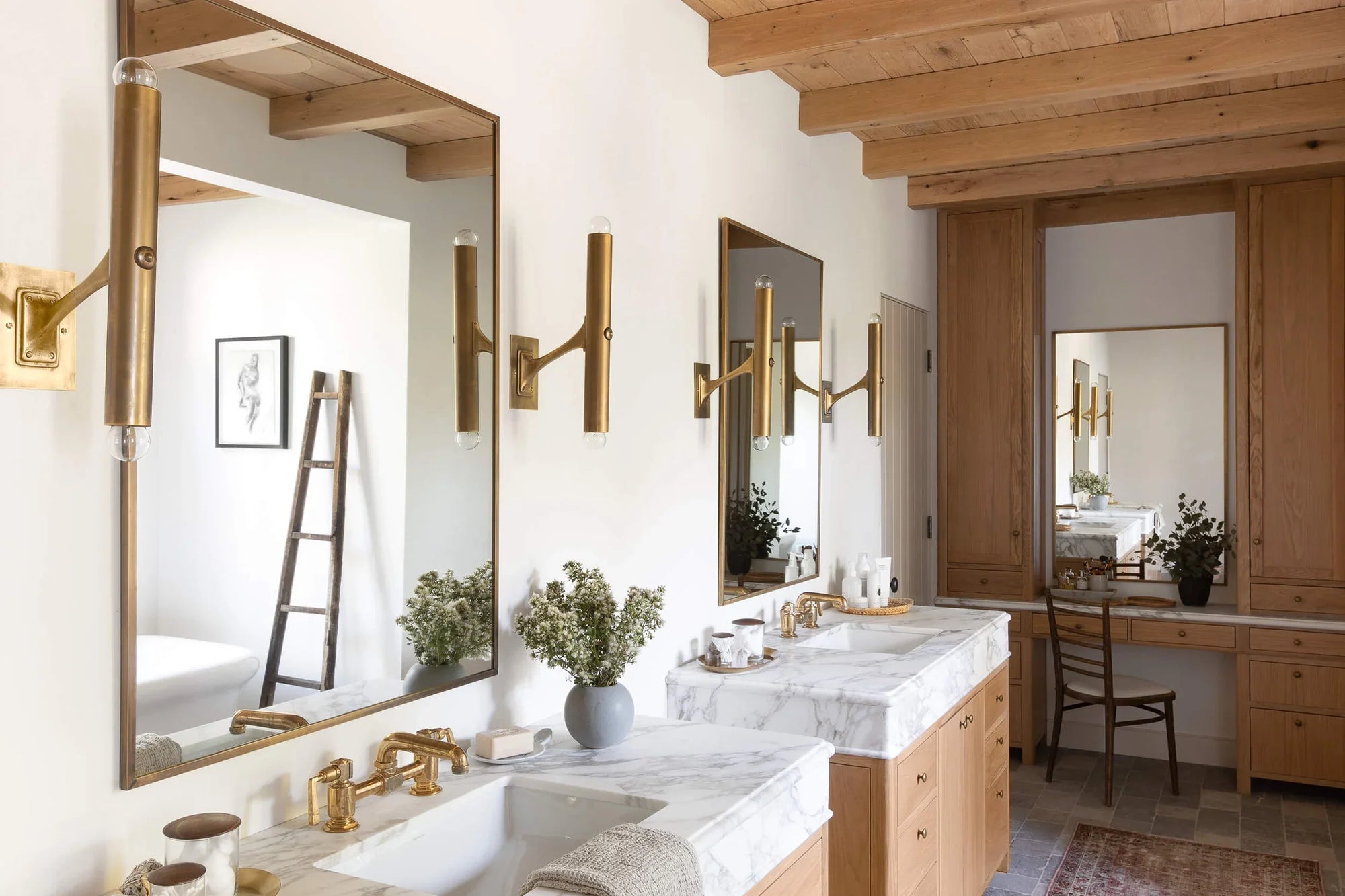 a stylish bathroom featuring two rectangular bathroom mirrors with sleek brass sconces, modern marble countertops, and wooden cabinetry. | ACE DECOR