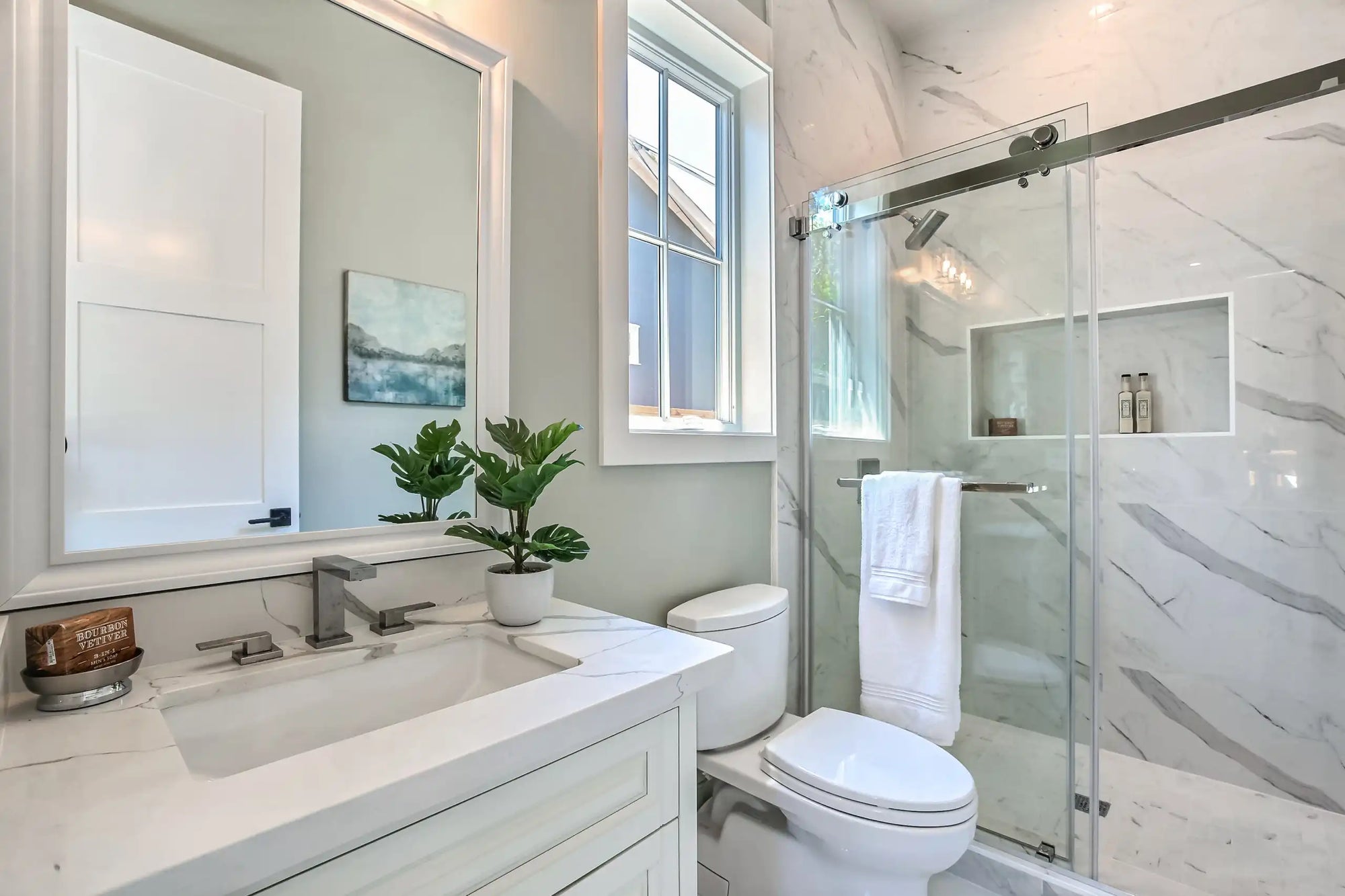 The image shows a modern bathroom with a sleek frameless sliding shower door, featuring elegant design and minimalistic decor. | ACE DECOR