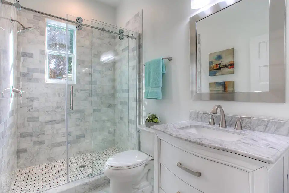 This image shows a modern bathroom with a sleek shower area featuring shower doors glass sliding and stylish marble tiles. | ACE DECOR