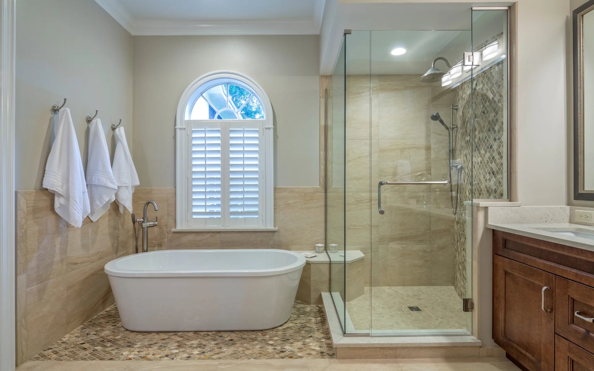 a luxurious bathroom featuring a frameless shower door, a freestanding bathtub, and elegant tilework for a sophisticated spa-like feel. | ACE DECOR