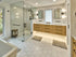Spacious bathroom with glass shower, floating vanity, and hexagonal tile floor | modern shower ideas | Ace Decor