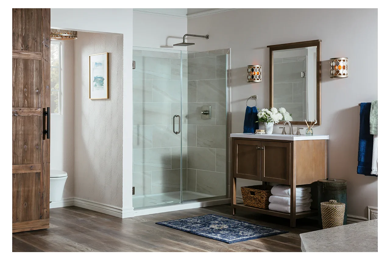 a modern bathroom with a sleek frameless shower door, stylish vanity, and a cozy, inviting atmosphere. | ACE DECOR