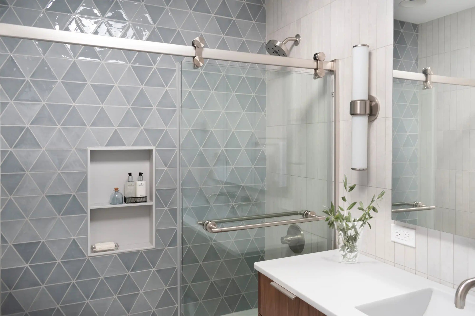 The image shows a modern bathroom with sliding glass shower doors frameless, featuring a sleek design and elegant tile work. |ACE DECOR