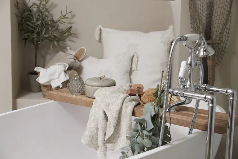 a serene bathroom setup featuring a bathtub and shower faucet with a vintage-style chrome finish, complemented by cozy textiles, natural elements, and spa-like accessories for a relaxing ambiance. | ACE DECOR