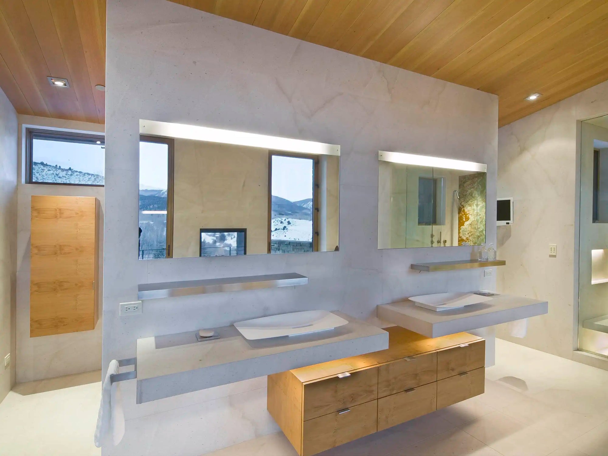 A modern double-sink bathroom with clean lines, wood accents, and a frameless vanity mirror enhancing the bright, open design. | ACE DECOR