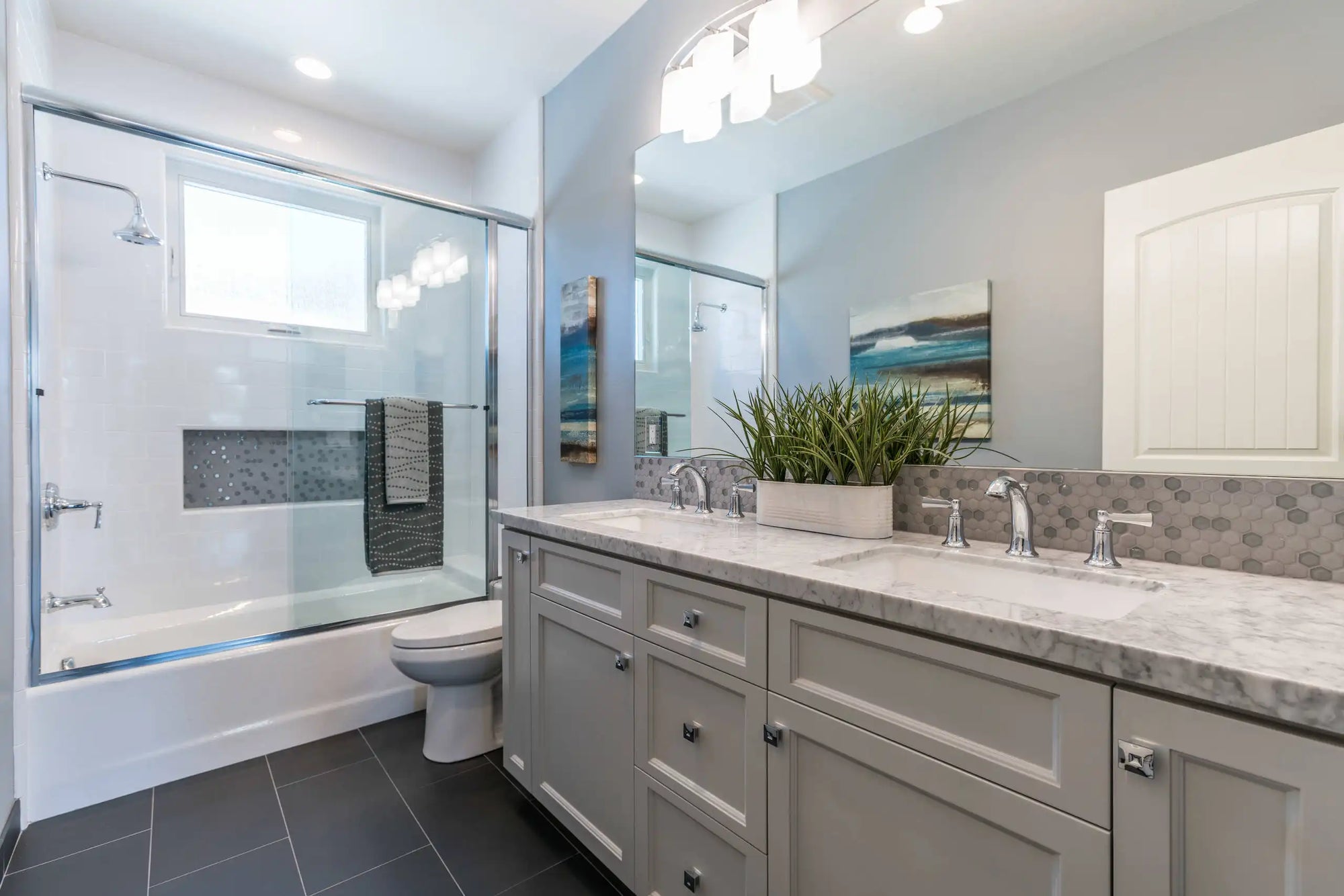 A modern bathroom featuring sleek bathroom shower sliding glass doors with a built-in towel bar, set against a clean, neutral-toned vanity and stylish decor. | ACE DECOR