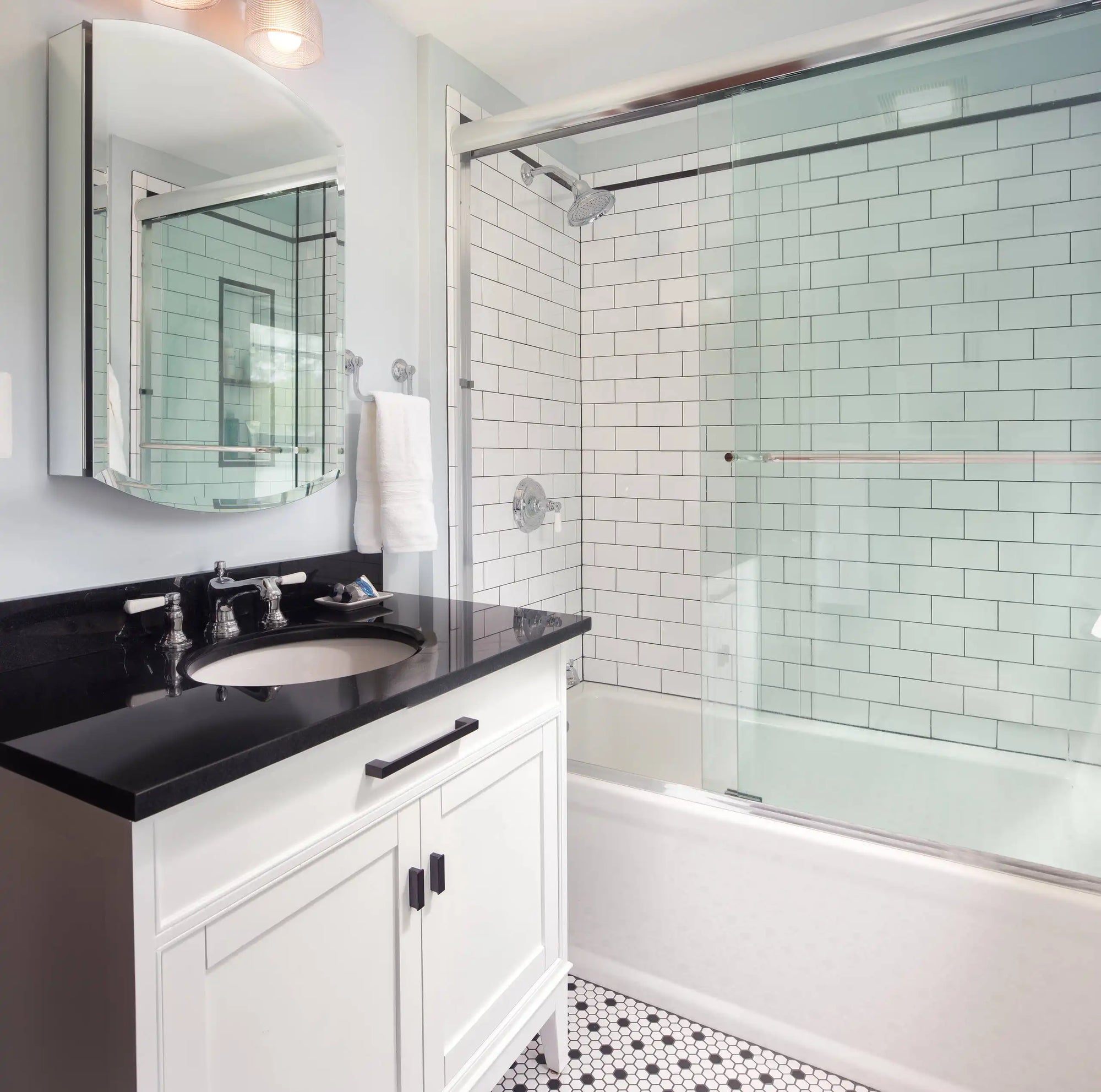 The image showcases a modern bathroom with a sleek bathtub and a clear shower doors glass sliding setup. |ACE DECOR