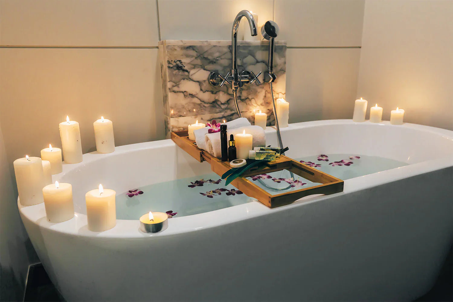 A luxurious bathtub setup with candles, flower petals, and spa essentials, creating a serene and relaxing ambiance. | ACE DECOR