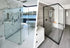 A side-by-side comparison of a frameless shower door (left) and a semi-frameless shower door with a black frame (right) in modern bathroom settings. | ACE DECOR