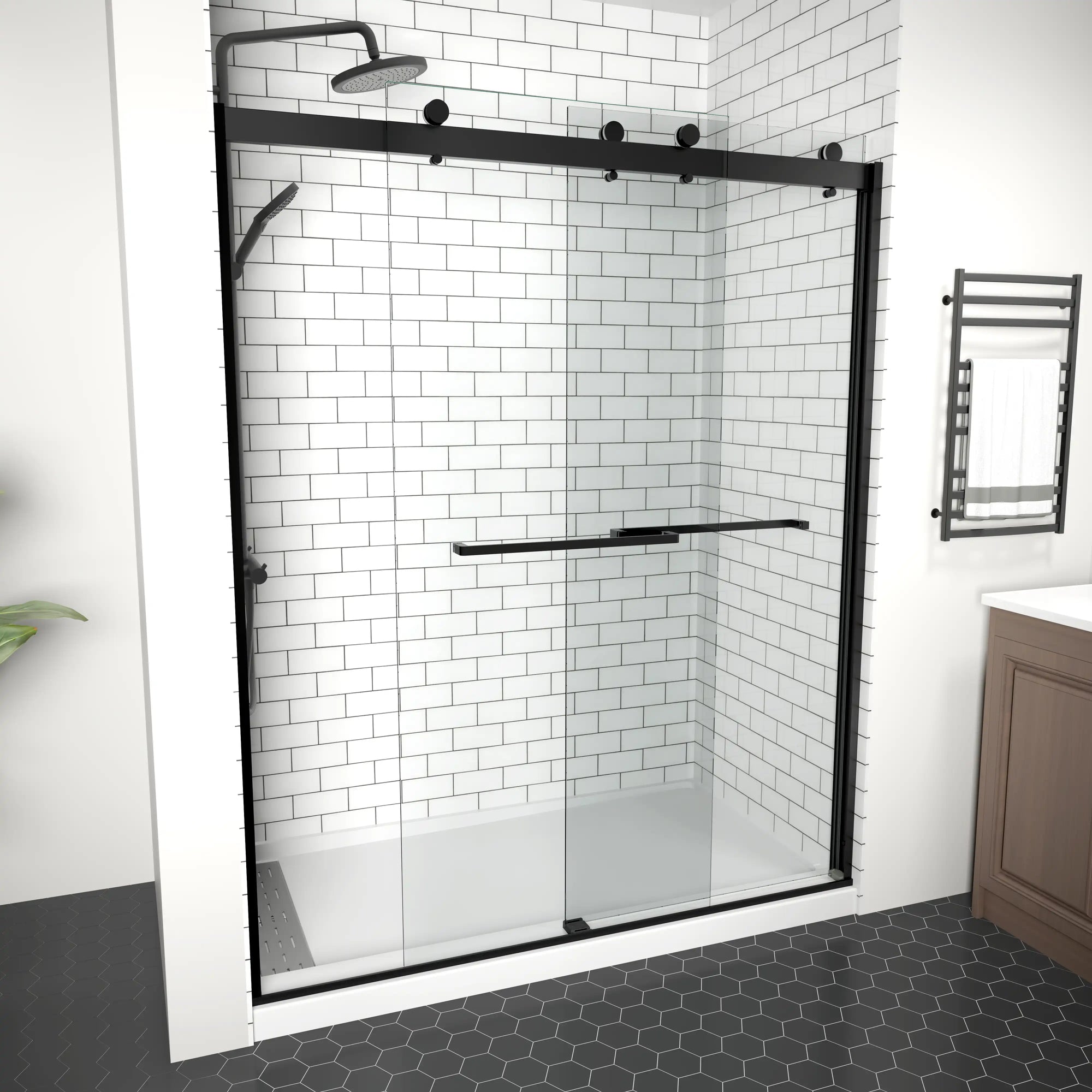 Modern frameless shower door with black fixtures, white subway tiles, and dark contrasting floor in contemporary bathroom.